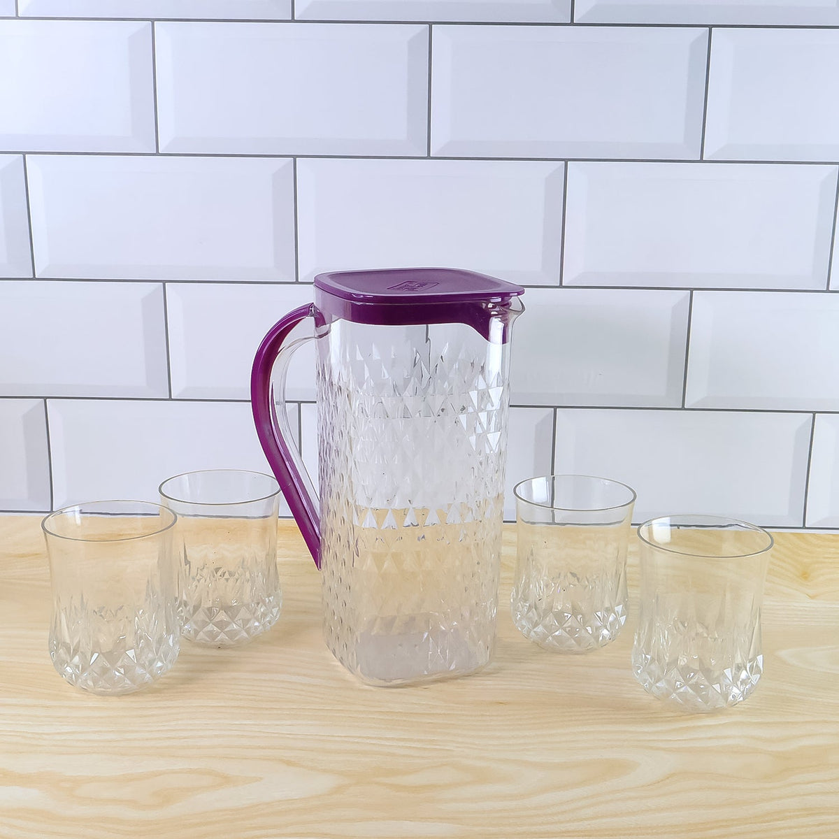 Side view of BPA-free plastic jug and glasses combo set with easy pour design