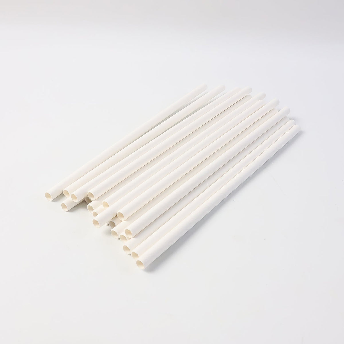 Eco-friendly paper straws displayed with green leaf, highlighting sustainable use