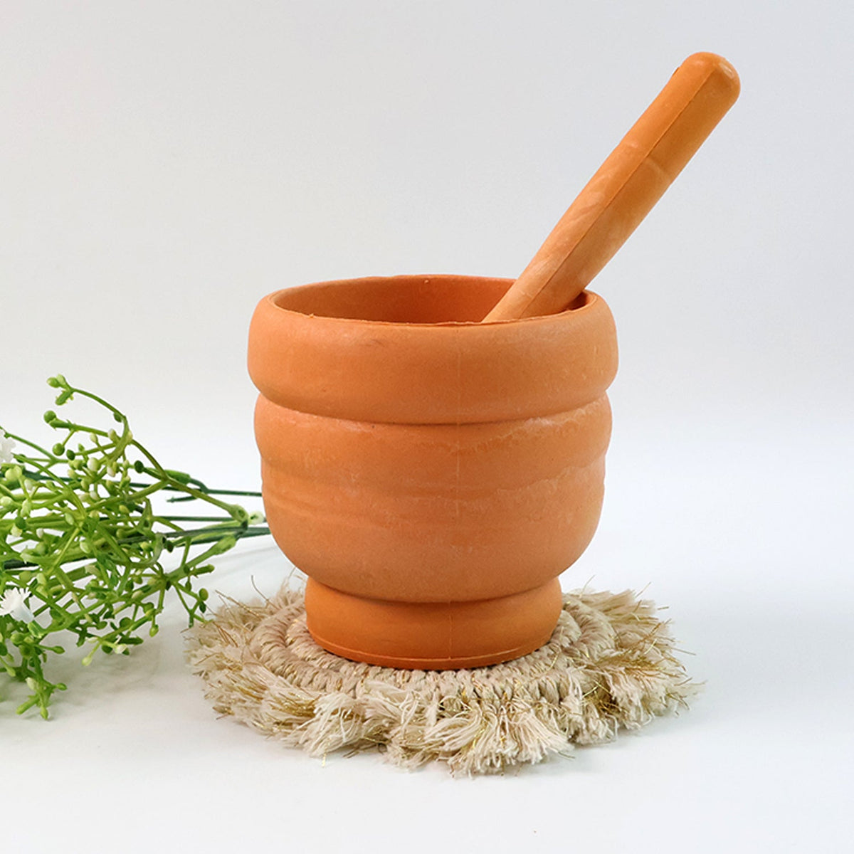 Unbreakable plastic mortar and pestle set with the ergonomic pestle resting inside the bowl.